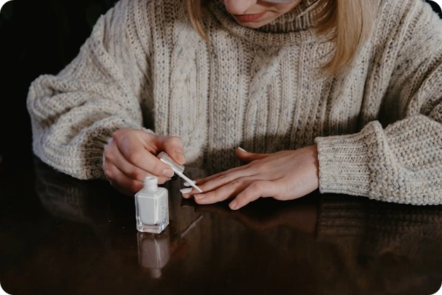 Woman applying nail polish to her nails