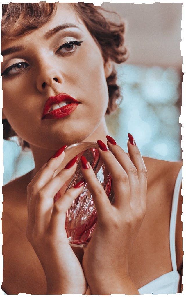 a woman holding an ambergris parfume