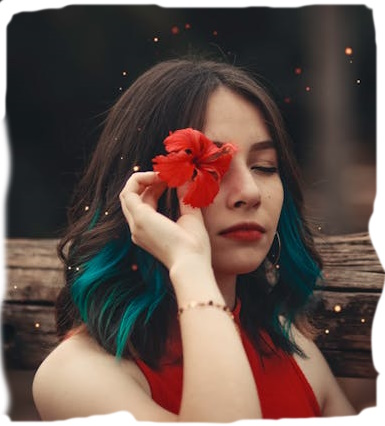 A person holding a hibiscus flower