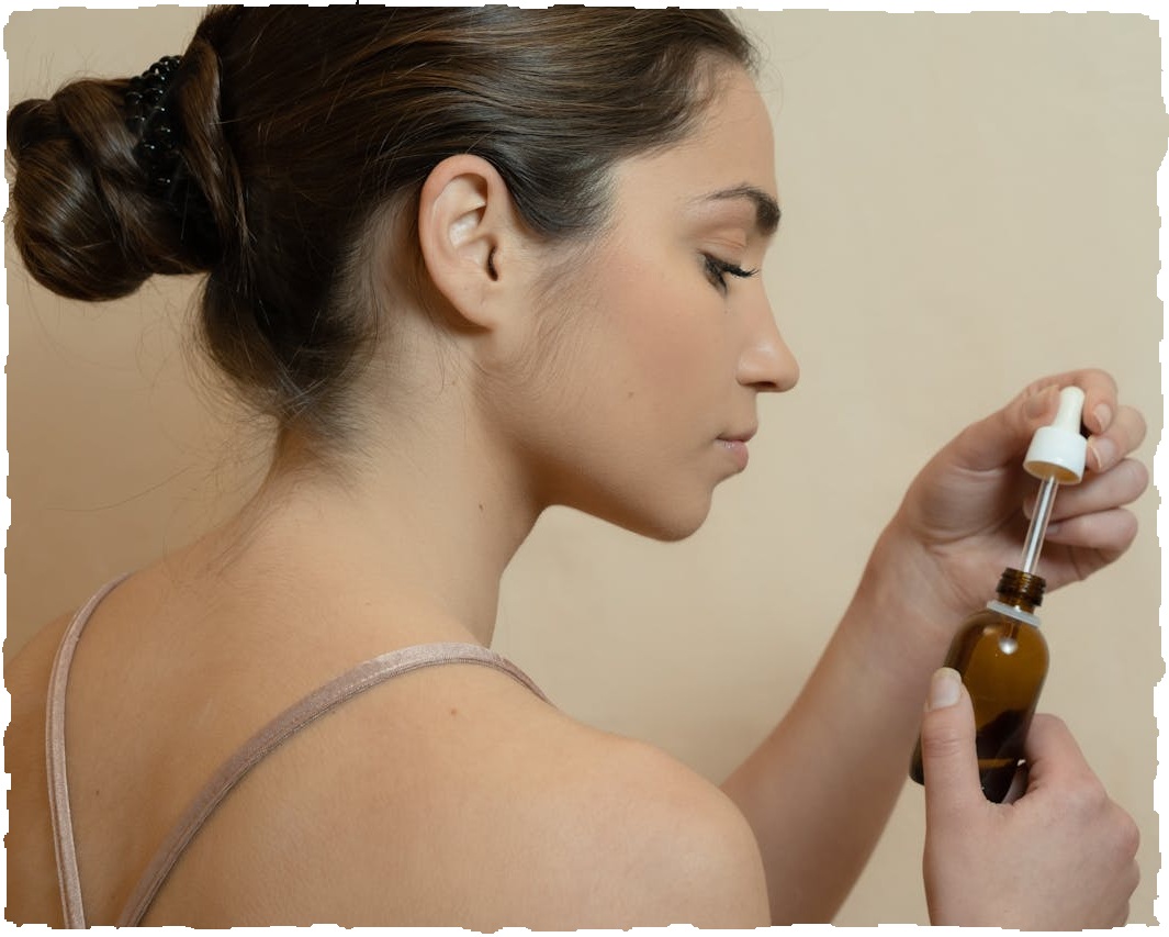 a woman applying oil to her skin