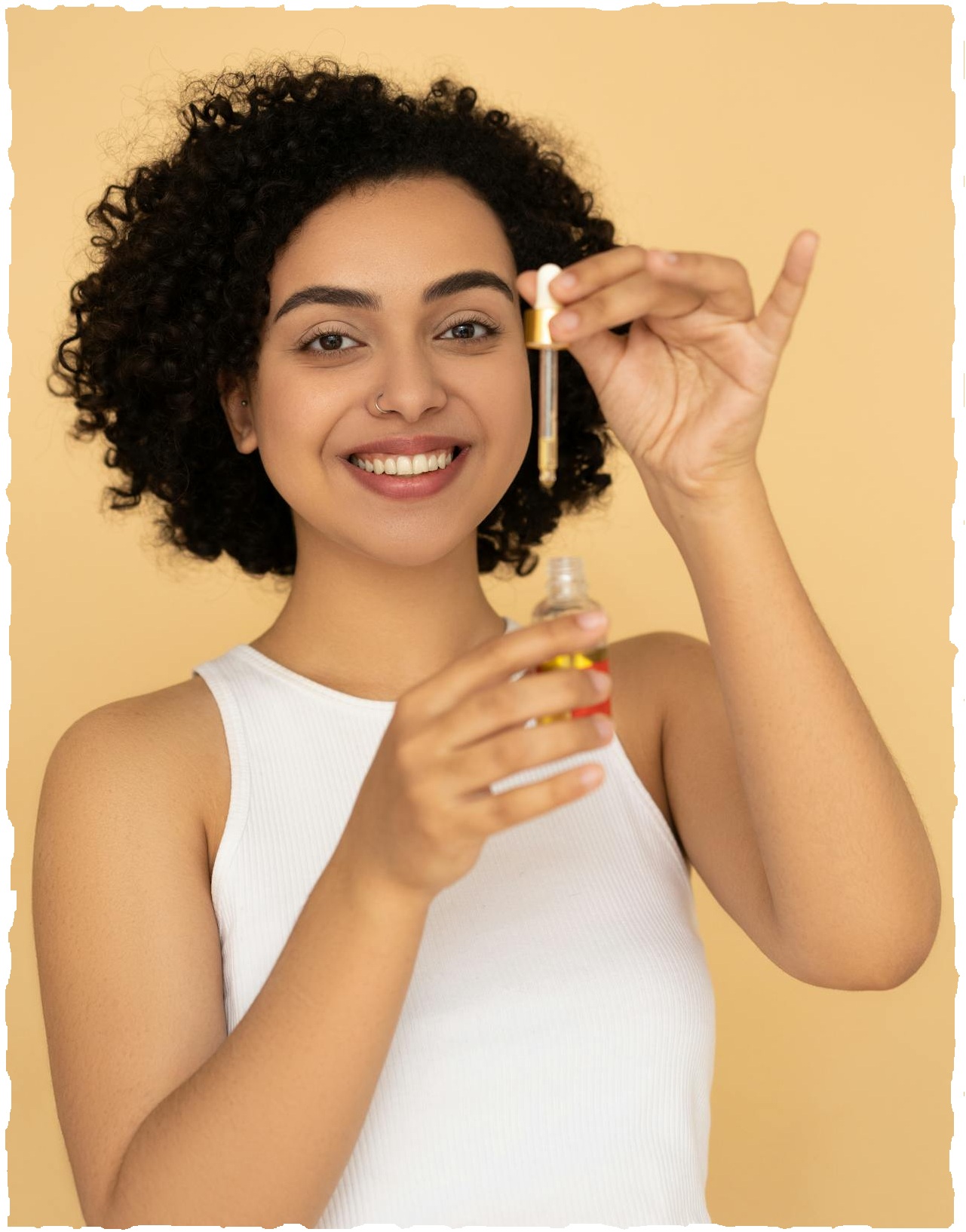 A woman holding an essential oil bottle